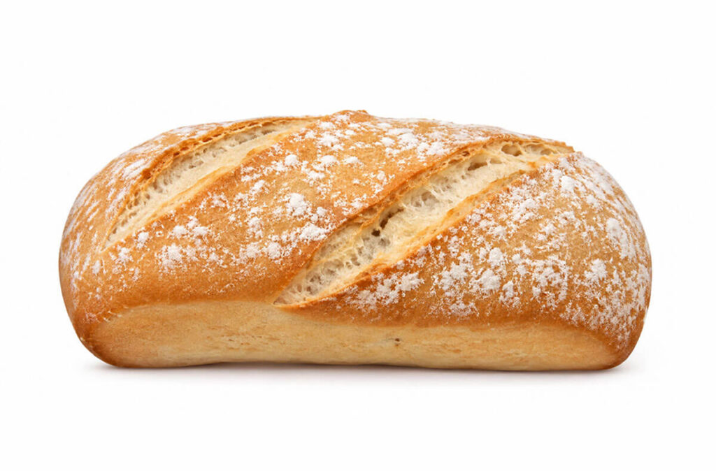 Chapata de pan con corteza dorada, enharinada y acabado rústico.